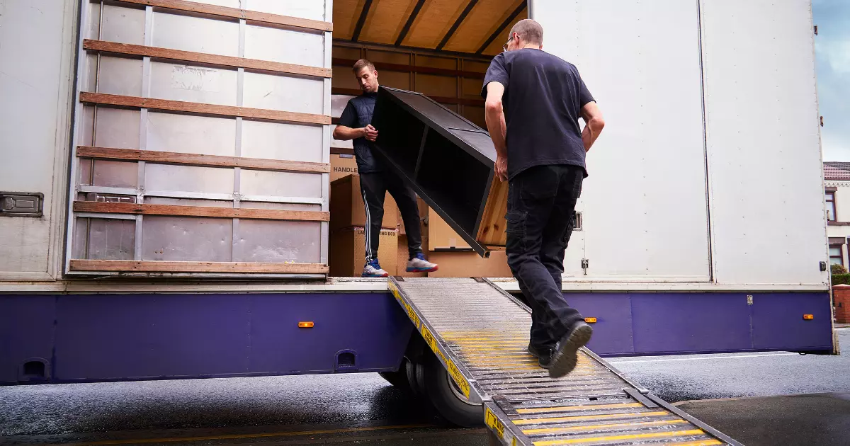 Team loading furniture into a truck as part of a commercial junk removal service