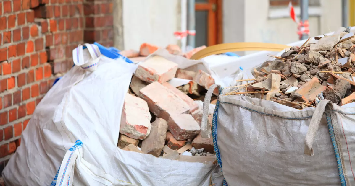 Bags filled with mixed rubble and broken bricks for construction debris removal at a job site